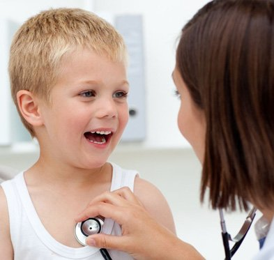 A happy child laughing with the pediatrician